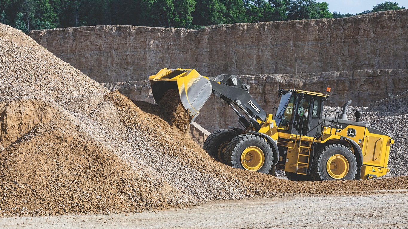 Large image of the 744 X-Tier dumping rocks and dirt on the jobsite